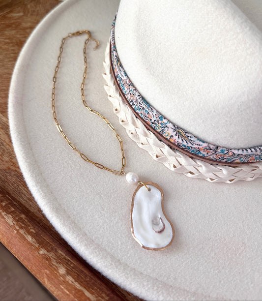 Necklace with a unique pendant on a white plate